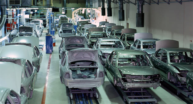 white car bodies on a factory line